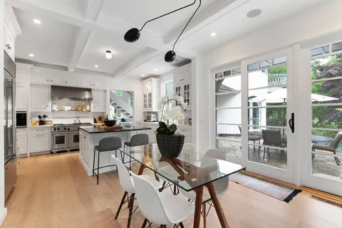 a living room with stainless steel appliances kitchen island granite countertop furniture and a view of kitchen