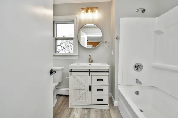 a bathroom with a sink a vanity and a mirror