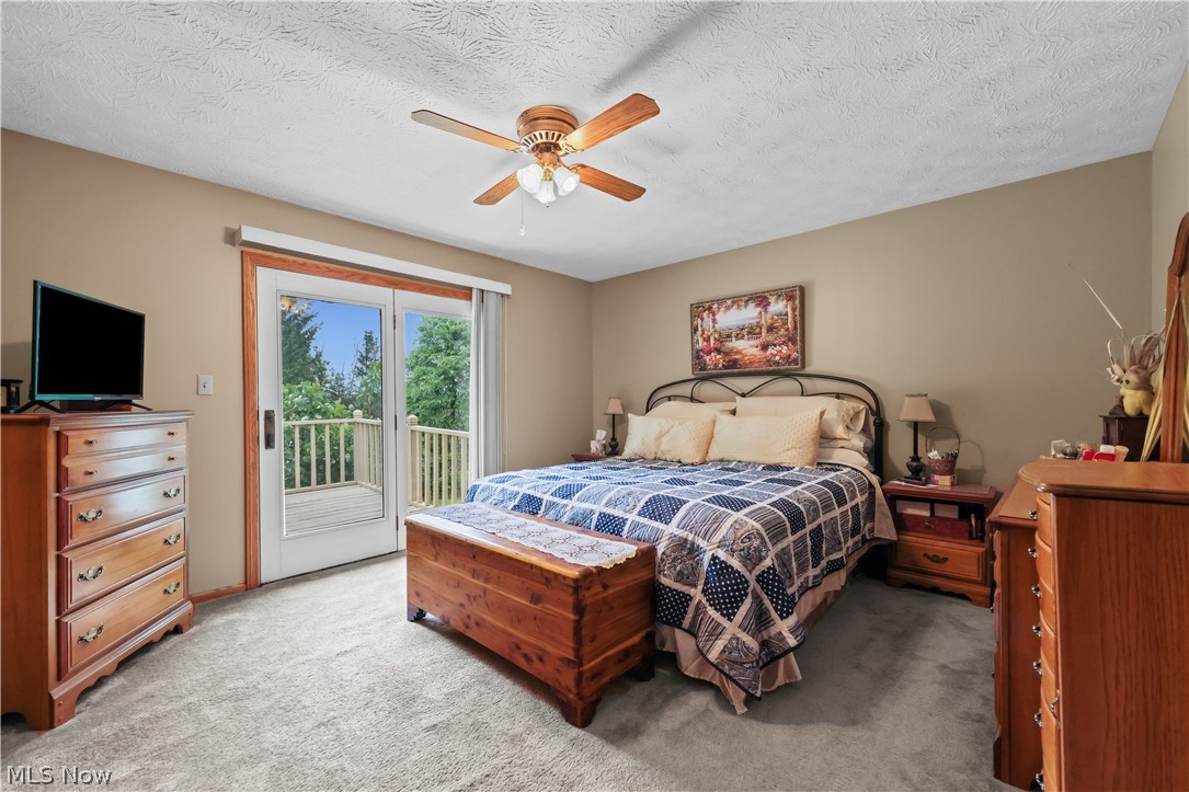 1835 Lynn Road Kent, OH 44240 - Photo 19 of 48 Bedroom featuring neutral wall color, light-toned carpeting, a ceiling fan with light fixture, and double glass doors opening to an outdoor deck