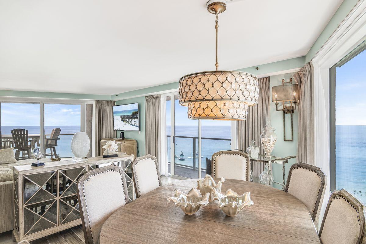 4323 Beachside 2, Unit 323 Miramar Beach, FL 32550 - Photo 1 of 41 a dining room with furniture a chandelier and wooden floor