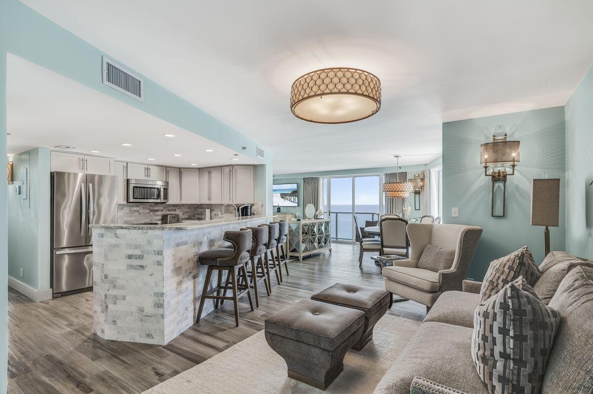 4323 Beachside 2, Unit 323 Miramar Beach, FL 32550 - Photo 14 of 41 a living room kitchen with stainless steel appliances kitchen island granite countertop a couch and a stove top oven
