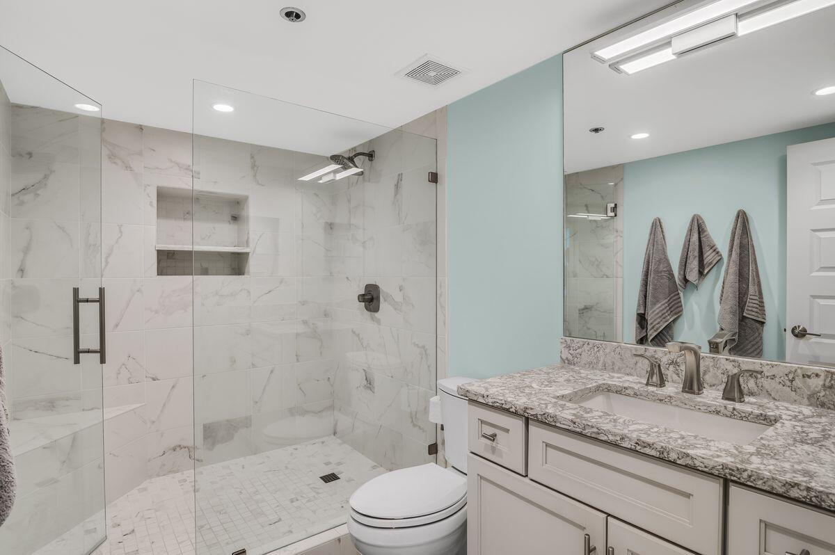4323 Beachside 2, Unit 323 Miramar Beach, FL 32550 - Photo 21 of 41 a bathroom with a granite countertop sink a toilet and shower