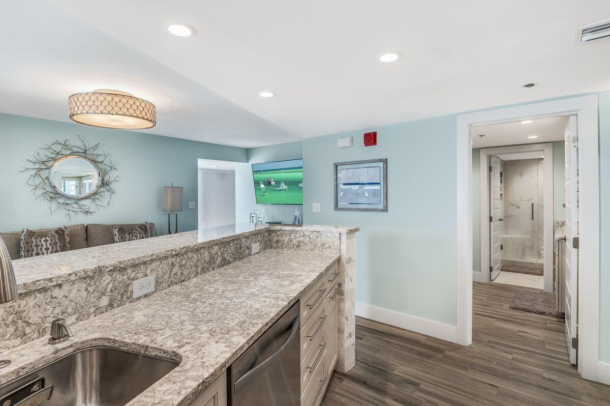 4323 Beachside 2, Unit 323 Miramar Beach, FL 32550 - Photo 24 of 41 a kitchen with granite countertop a sink and a stove