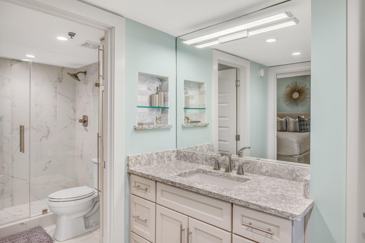 4323 Beachside 2, Unit 323 Miramar Beach, FL 32550 - Photo 25 of 41 a bathroom with a granite countertop sink a toilet and shower