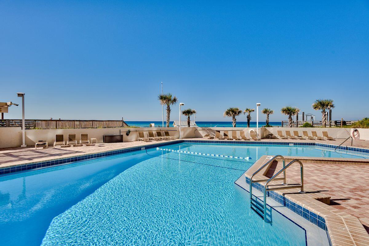 4323 Beachside 2, Unit 323 Miramar Beach, FL 32550 - Photo 28 of 41 a kitchen with stainless steel appliances kitchen island granite countertop a sink and cabinets