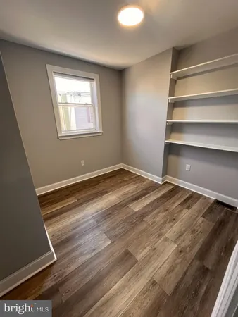 a view of room with window and ceiling fan