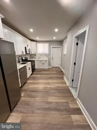 a view of kitchen with sink microwave and refrigerator
