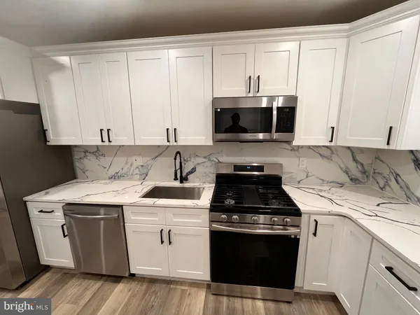 a kitchen with a stove and a microwave