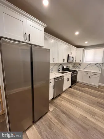 a kitchen with stainless steel appliances granite countertop a refrigerator sink and cabinets