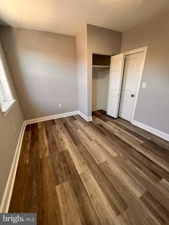 a view of room with wooden floor