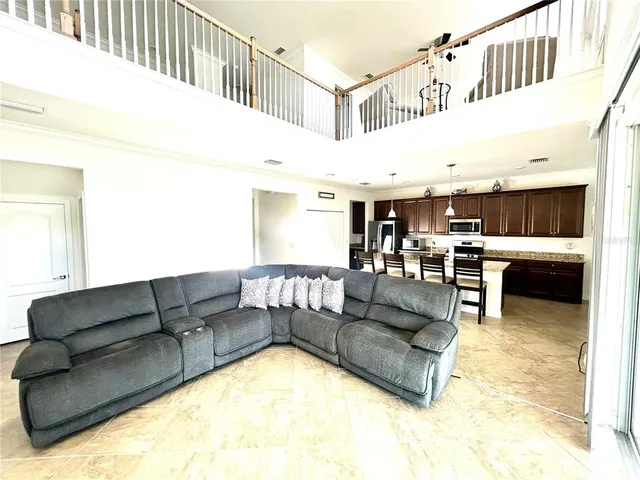 a living room with furniture and kitchen view