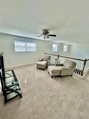 a bedroom with furniture and a ceiling fan