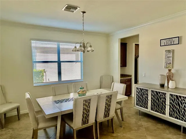a dining room with furniture and window