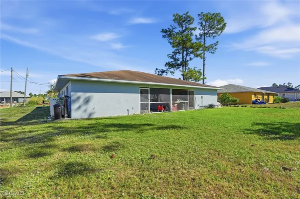 a front view of house with yard and outdoor seating
