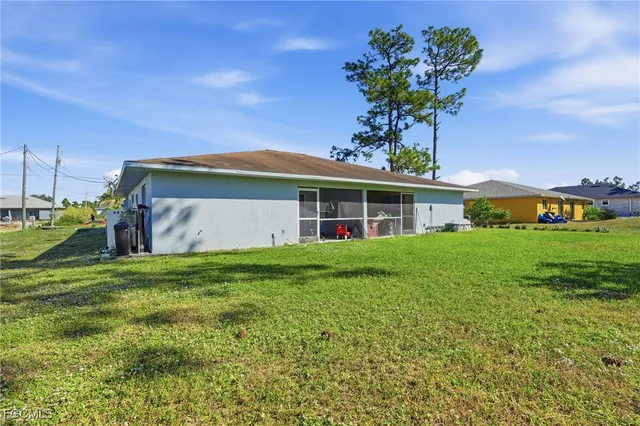 a front view of house with yard and outdoor seating
