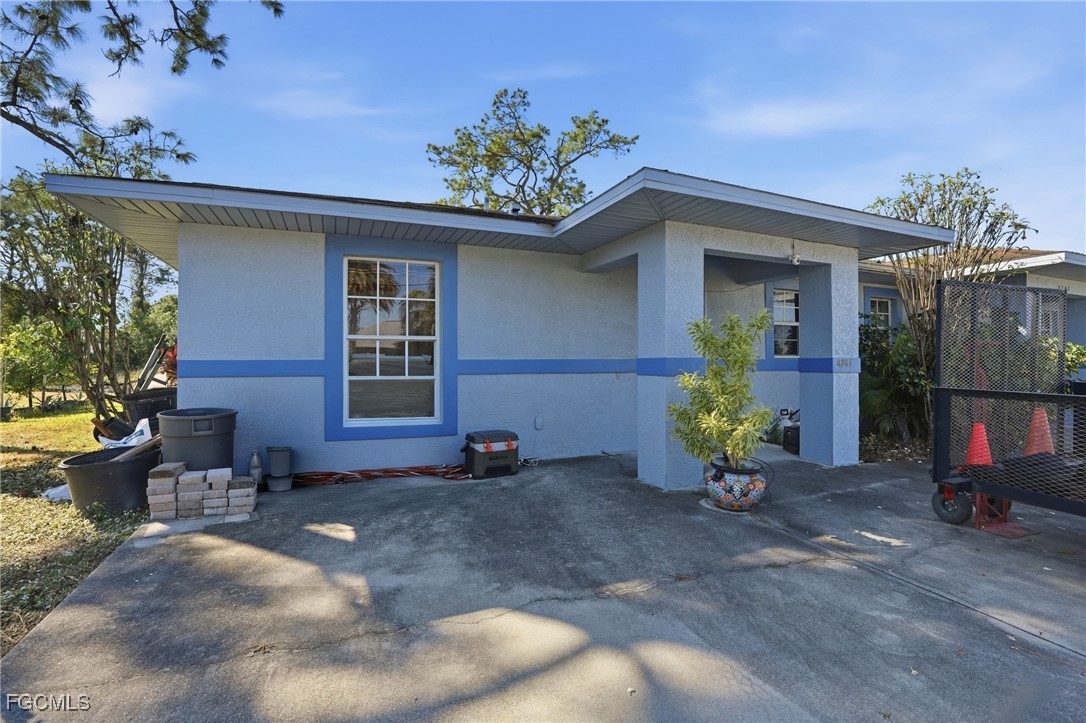 4741-4743 27th Street Southwest Lehigh Acres, FL 33973 - Photo 3 of 13 a front view of a house with yard