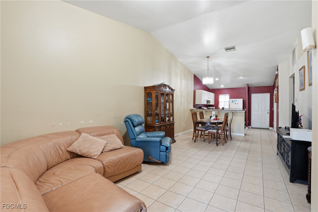 4741-4743 27th Street Southwest Lehigh Acres, FL 33973 - Photo 4 of 13 a living room with furniture and a flat screen tv