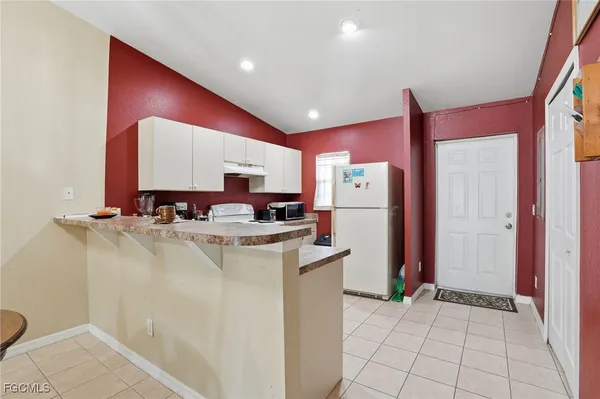 a kitchen with refrigerator and mirror