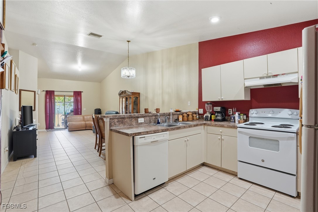 4741-4743 27th Street Southwest Lehigh Acres, FL 33973 - Photo 9 of 13 a kitchen with a sink stove and cabinets