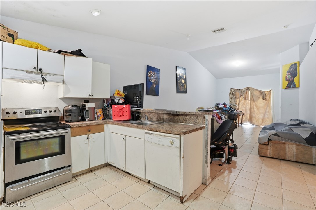 4741-4743 27th Street Southwest Lehigh Acres, FL 33973 - Photo 10 of 13 a kitchen with a sink cabinets and stainless steel appliances