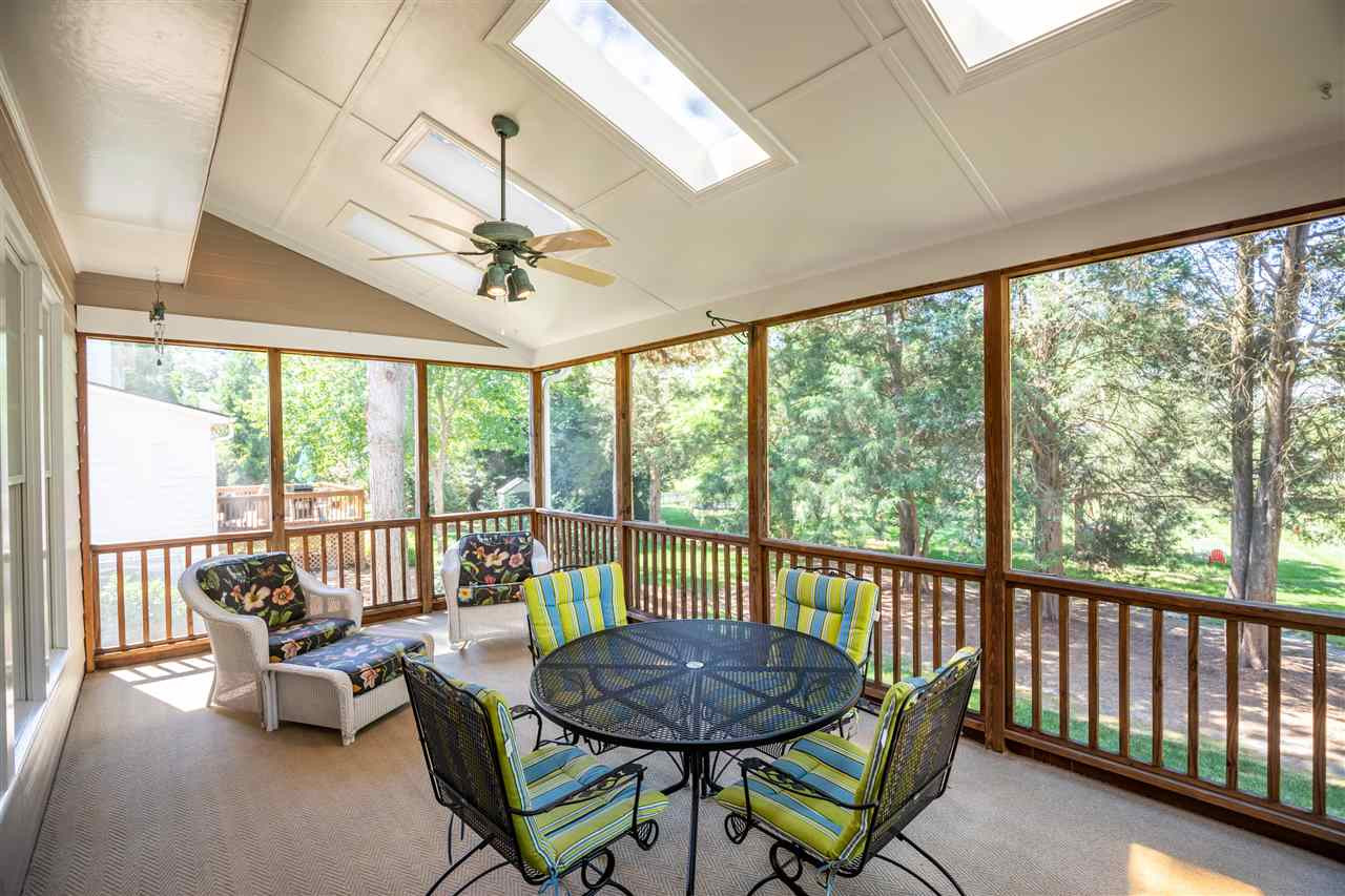 2709 Amstel Way Raleigh, NC 27613 - Photo 26 of 30 Enjoy the privacy of your backyard on the carpeted screened porch equipped with a ceiling fan to cool down those hot summer days! Screened Porch