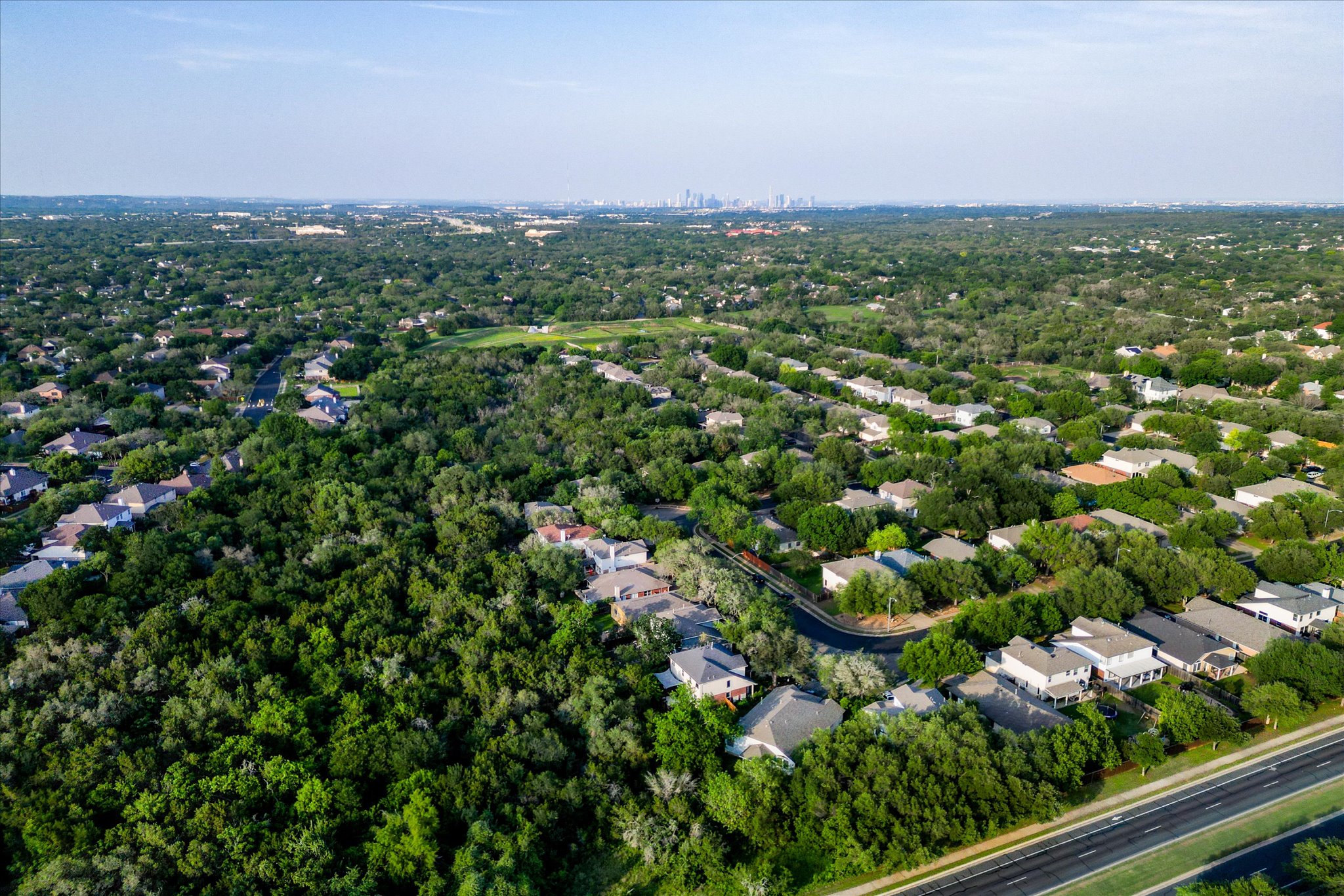 8920 West Hove Loop Austin, TX 78749 - Photo 30 of 39 Expansive aerial perspective showcasing a residential area enveloped by extensive tree coverage