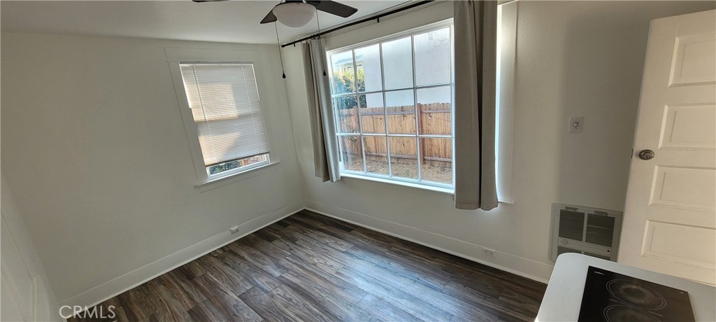 833 Cedar Avenue Long Beach, CA 90813 - Photo 7 of 15 a view of an empty room with wooden floor and a window