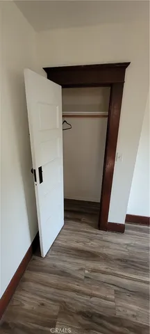 a view of walk in closet with wooden floor