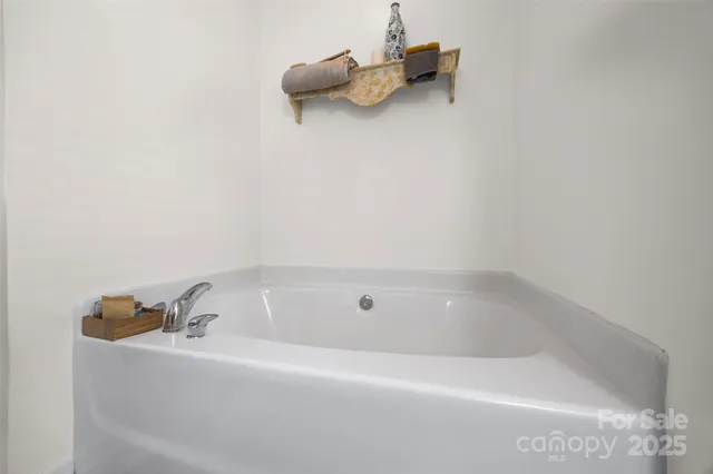 a white bath tub sitting next to a window