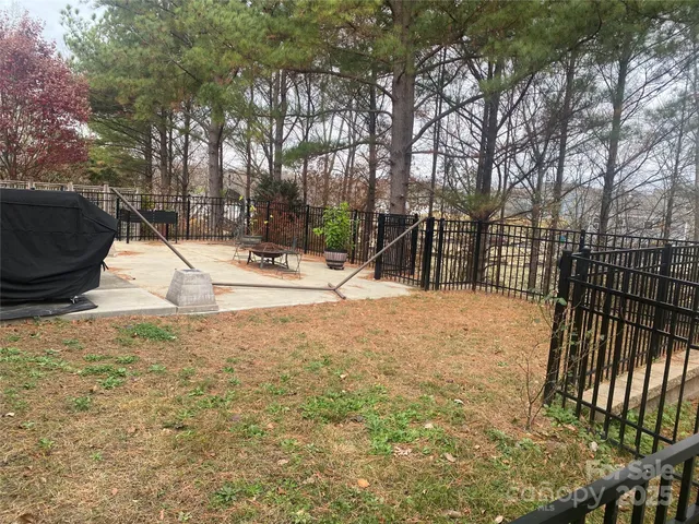 a view of backyard with large trees