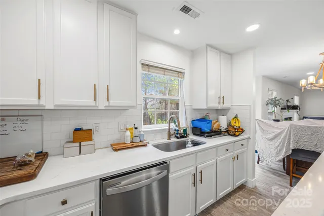 a kitchen with white cabinets and white appliances