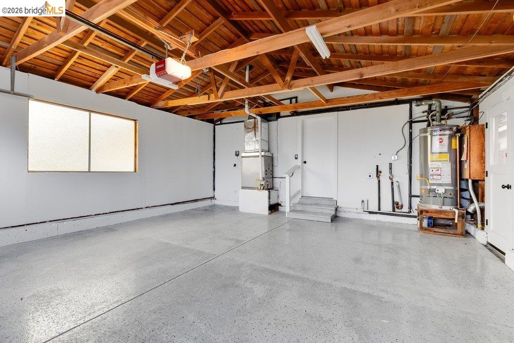 1298 Ribbon Street Foster City, CA 94404 - Photo 66 of 86 Spacious garage featuring an exposed beam ceiling, concrete flooring, and a large frosted window