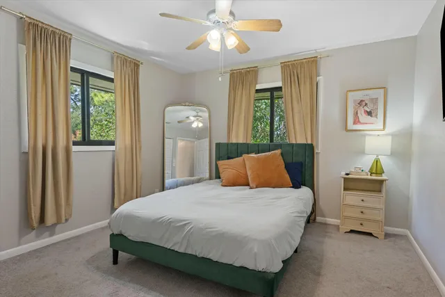 a bedroom with a bed dresser and a window