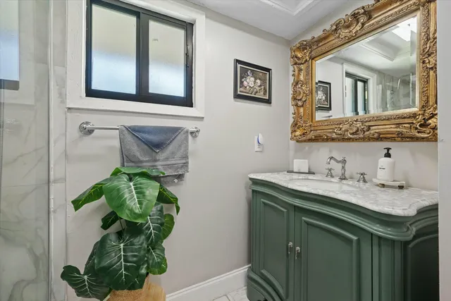 a bathroom with a sink a mirror and vanity