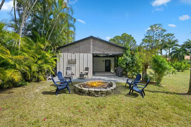 a swimming pool with outdoor seating and yard