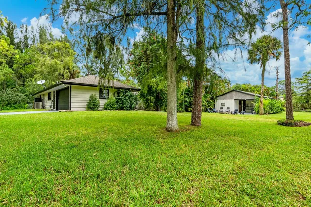 a view of an house with backyard space and garden