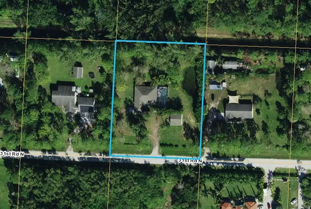 an aerial view of residential house with outdoor space and swimming pool