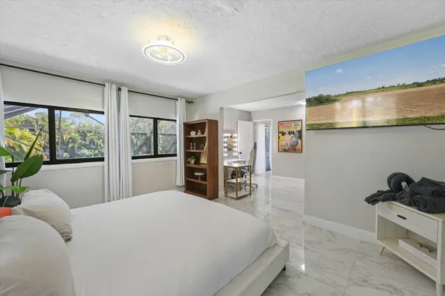 a bed room with a bed and a large window