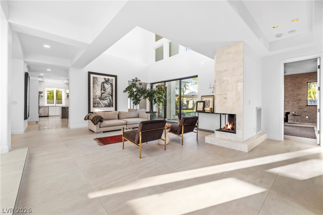 2000 Grouse Street Las Vegas, NV 89134 - Photo 6 of 89 An inviting open-concept living area with a sleek fireplace and ample natural light.