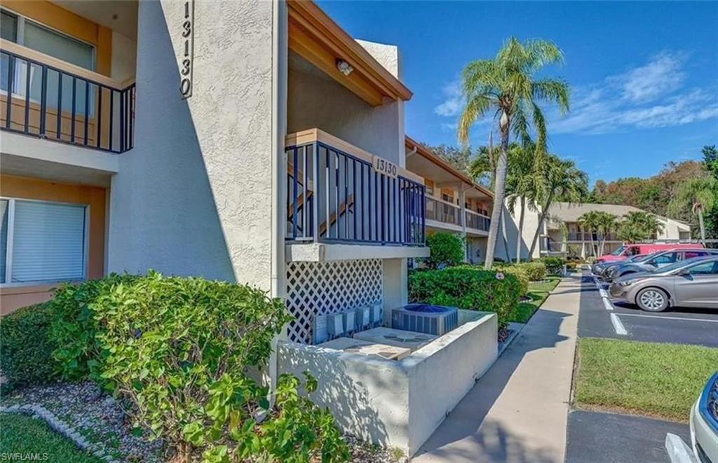13130 White Marsh Lane, Unit 207 Fort Myers, FL 33912 - Photo 12 of 15 a view of a house with a yard and a chair