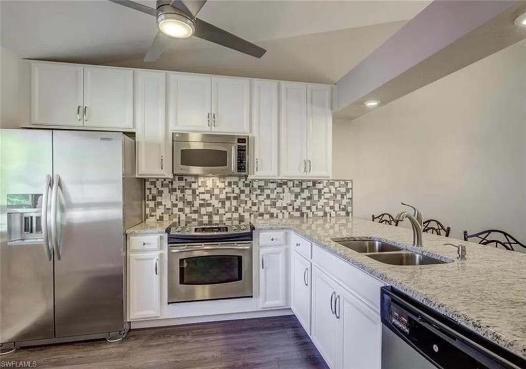 13130 White Marsh Lane, Unit 207 Fort Myers, FL 33912 - Photo 2 of 15 a kitchen with sink a microwave and refrigerator