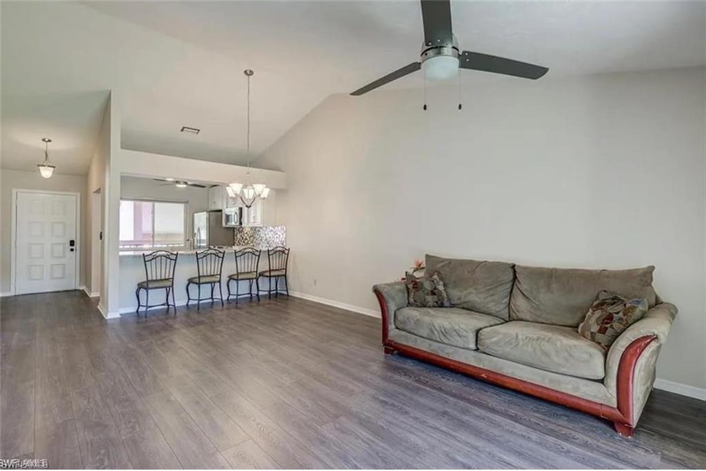 13130 White Marsh Lane, Unit 207 Fort Myers, FL 33912 - Photo 5 of 15 a living room with furniture and kitchen view