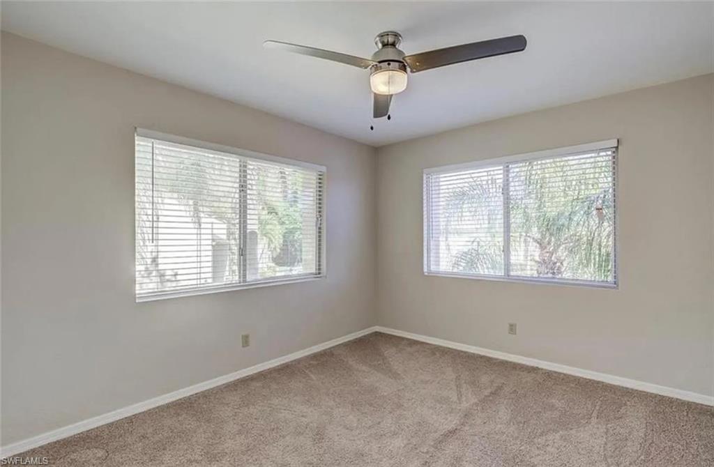 13130 White Marsh Lane, Unit 207 Fort Myers, FL 33912 - Photo 7 of 15 an empty room with a window and a fan