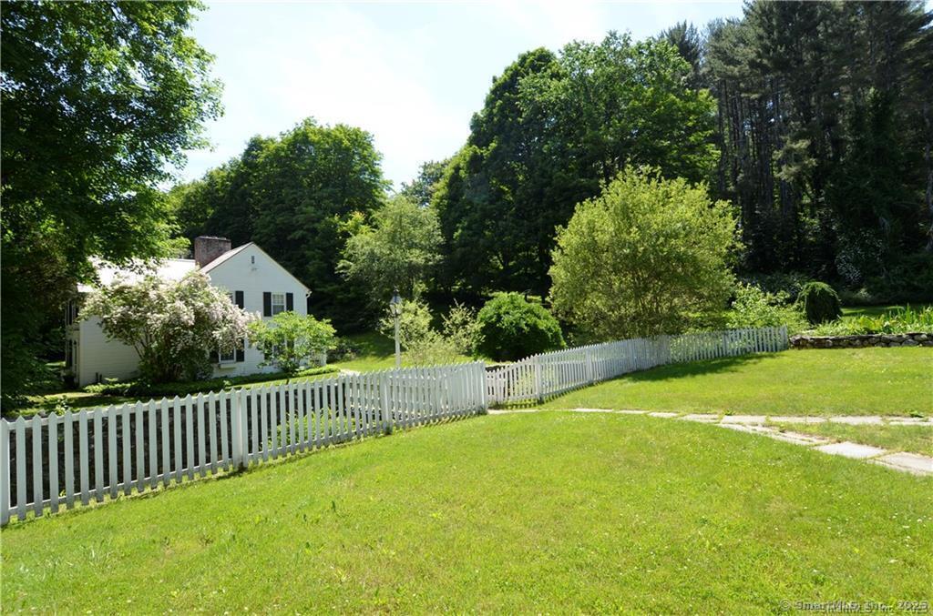 115 River Road Washington, CT 06794 - Photo 35 of 39 a view of a backyard with a small pool