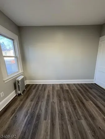a view of a room with wooden floor and window