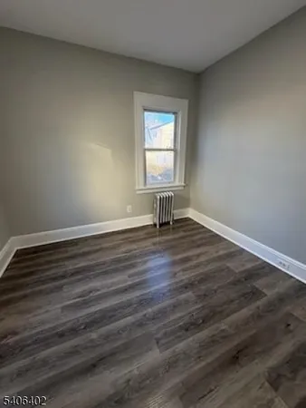 a view of wooden floor and windows in a room