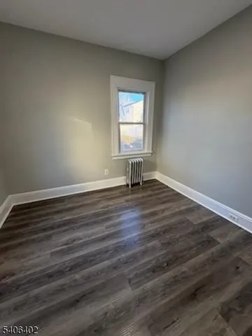 a view of wooden floor and windows in a room