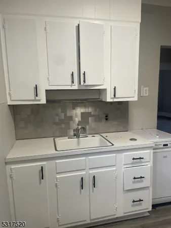 a kitchen with appliances cabinets and a sink