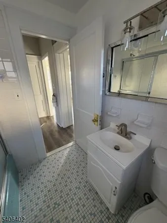 a bathroom with a sink a toilet and mirror