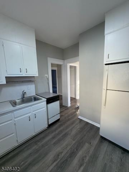 15 Ackerman Street, Unit 1 Bloomfield, NJ 07003 - Photo 21 of 23 a kitchen with granite countertop white cabinets and white appliances